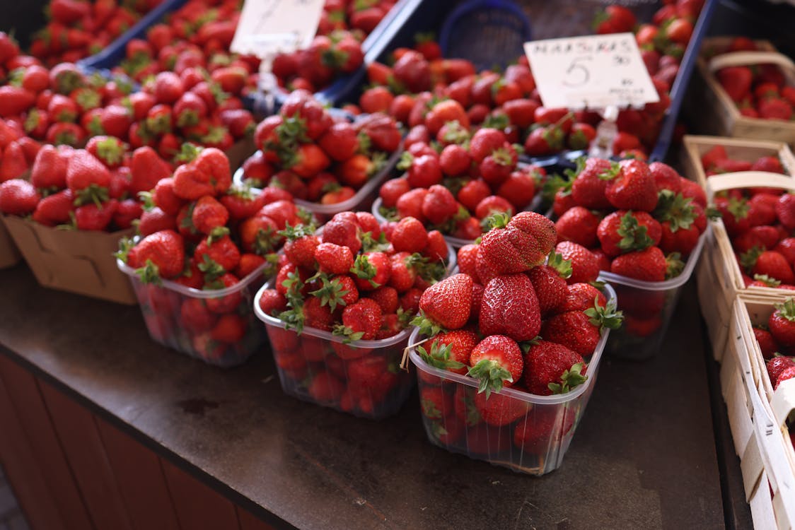 Fresh strawberries displayed at a spring farmers market stand